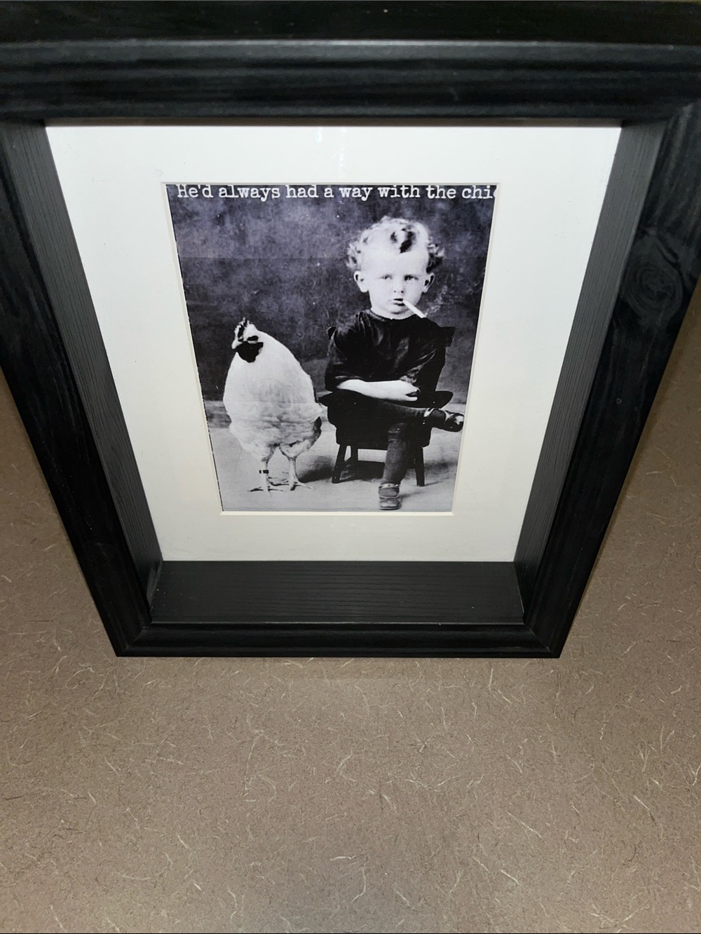 Fun Boy smoking with Rooster. Black and white 9”x11” with wood frame